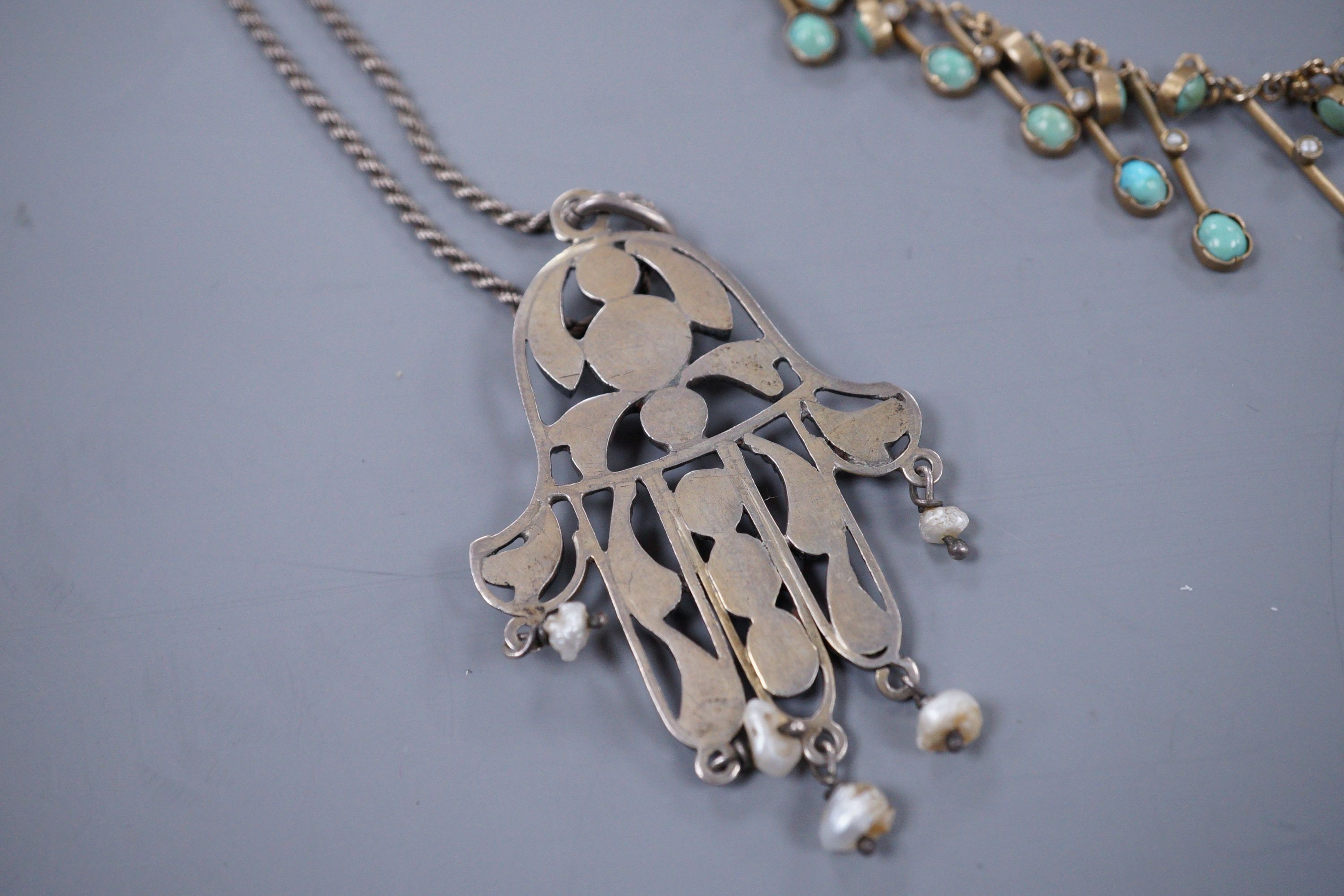 A Continental gem set white metal Hand of Fatima pendant, and a base metal turquoise set fringe necklace